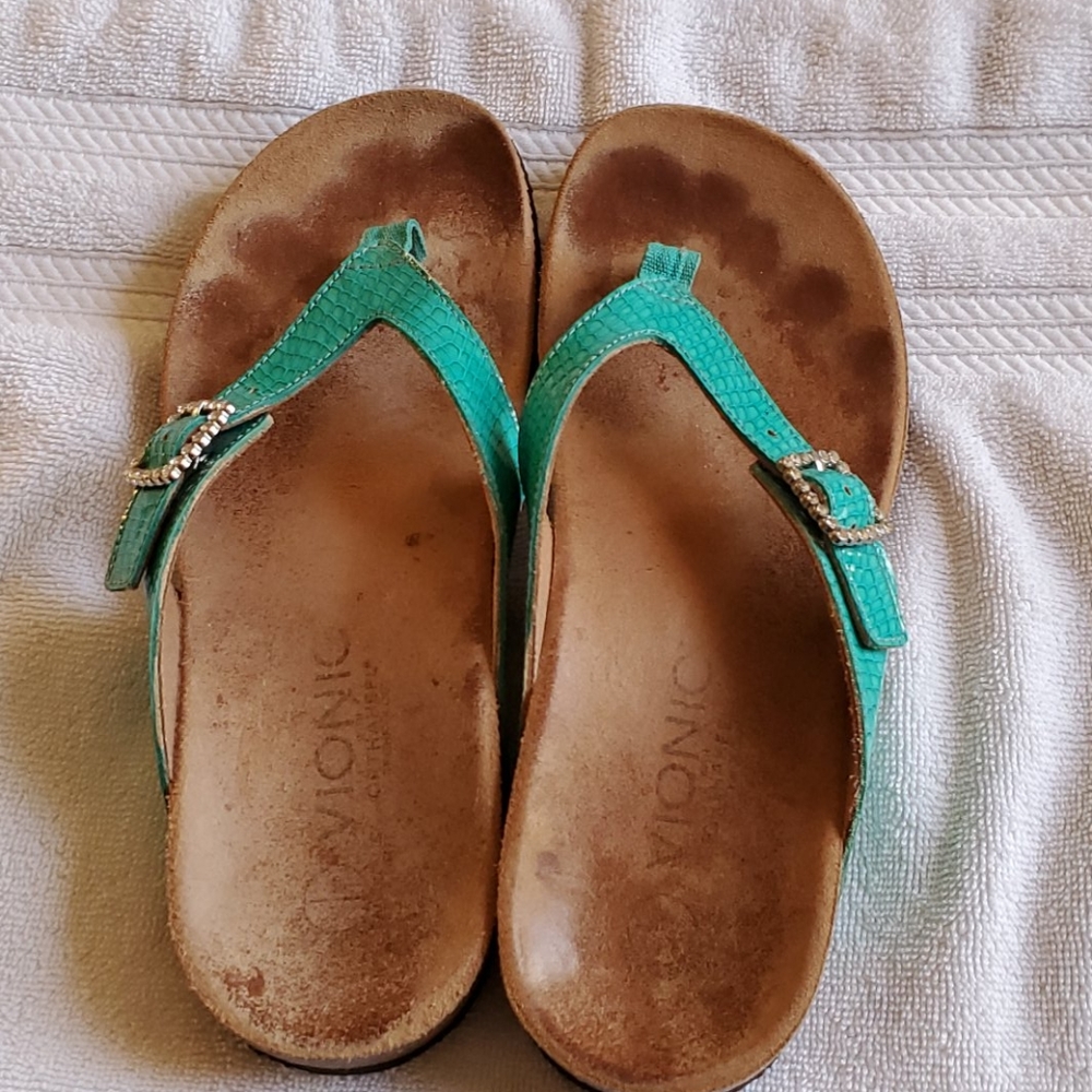 Used torqoise and tan sandals.